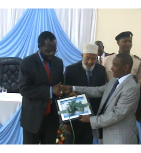 H.E Hon. Prof. Anyang' Nyong'o Minister for Medical Services, presented with a certificate of acquisition for Funsoft I-HMIS on behalf of Moi Teaching and Referral Hospital from Mr. Charles Waweru, Executive Director, System Partners limited